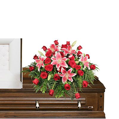 CALL FOR AVAILABILITY Stargazers and roses casket spray  in Houston, TX